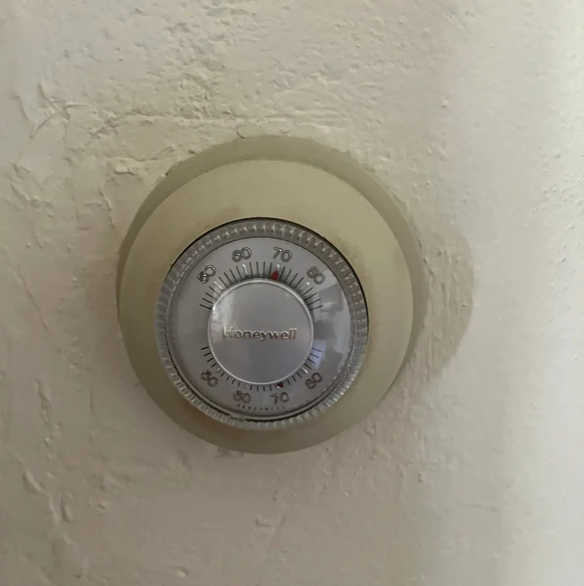 Old analog Honeywell thermostat with manual dial controls